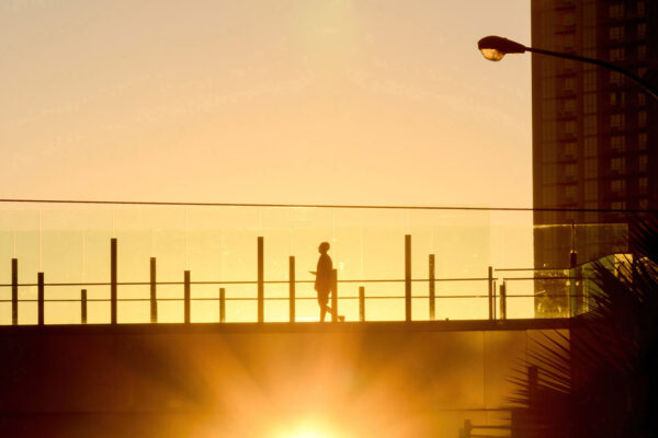 photography silhouette technique - man walking on a bridge in Las Vegas during the golden hour, sunrise