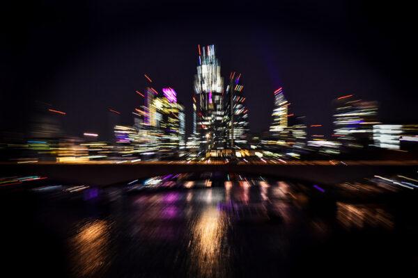 Photography zoom burst technique - beautiful London city lights and reflections in the Thames
